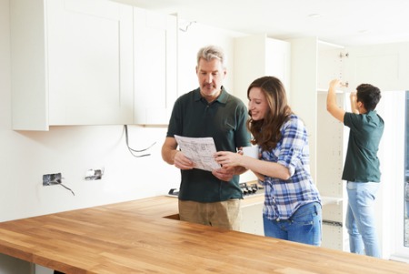 Couple looking at kitchen upgrades for new home